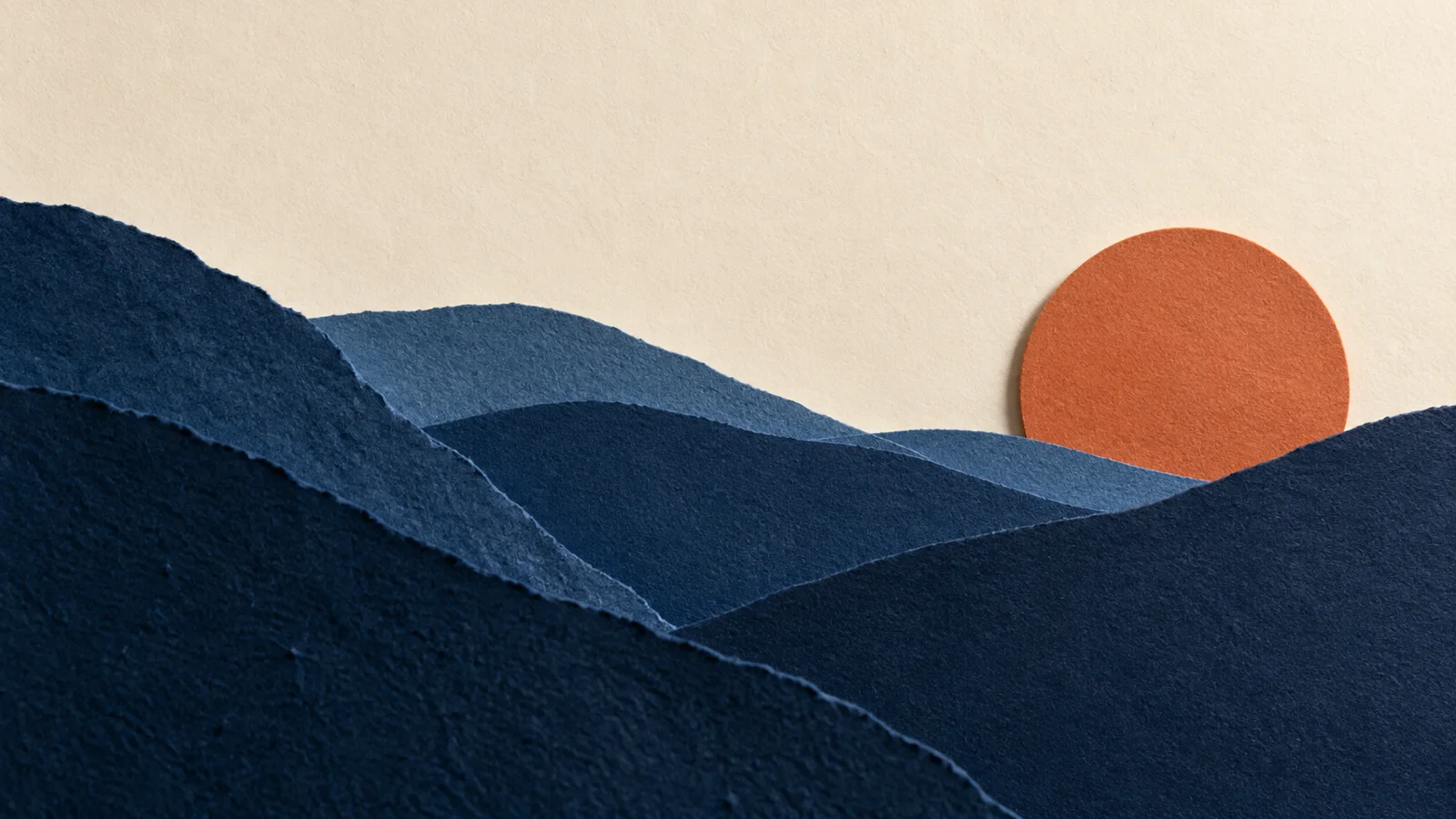 Layered blue paper mountains and an orange sun, an illustrative image concept.